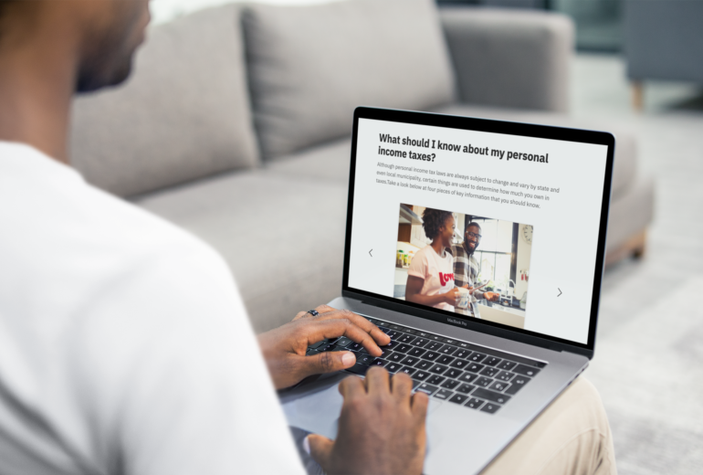 Man sitting on couch taking online course about income taxes.