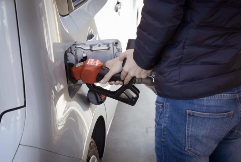 A person pumping gas.